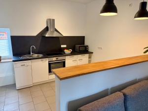 a kitchen with a sink and a stove top oven at FeWo Gretl Stauden in Walkertshofen