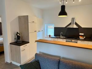 a kitchen with a counter and a sink and a refrigerator at FeWo Gretl Stauden in Walkertshofen