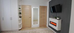 a living room with a fireplace and a tv at AirApartment in Chişinău