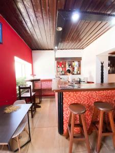 a kitchen with a counter and stools in a restaurant at Jiro Hôtel in Antananarivo