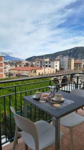 a table and chairs on a balcony with a view at Casa Michela in Sant'Agnello