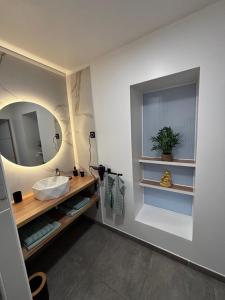 a bathroom with a sink and a mirror at L Orée des Thermes in Saint-Amand-les-Eaux +15 photos
