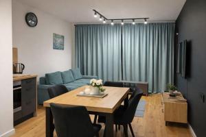 a living room with a table and a blue couch at MODERN APARTAMENT Walendów Park in Walendów