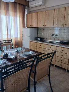 a kitchen with a wooden table and chairs and a table and chairsktop at Anastasios Room's in Olympic Beach +21 photos