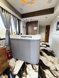 a room with a bed with a reputation sign on it at Hotel Sun Lake in Ahmedabad