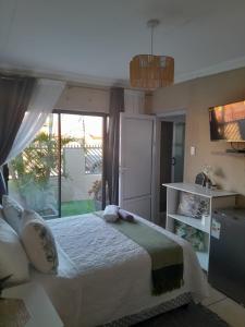 a bedroom with a bed and a large window at Guesthouse at 543 in Lebowakgomo +40 photos