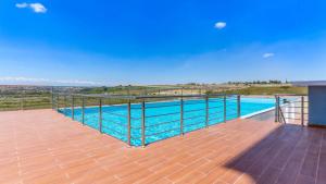 a balcony with a view of a swimming pool at Pride homes in Marimbeti