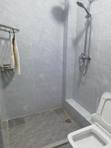 a bathroom with a shower and a toilet at Pride homes in Marimbeti
