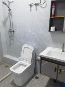 a bathroom with a toilet and a sink at Pride homes in Marimbeti