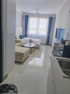a living room with a couch and a table at Pride homes in Marimbeti