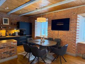 a dining room with a brick wall and a table and chairs at Arabella in Rakvere