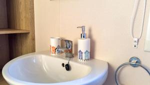 a bathroom sink with a faucet and towels on it at B3 Sunny Tides in Brixham +38 photos