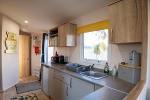 a small kitchen with a sink and a window at B3 Sunny Tides in Brixham