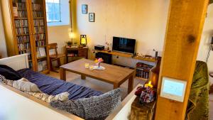 a living room with a couch and a table at SommerHuset in Samsø