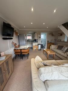 a large living room with a couch and a table at 30 Waterside in Corton