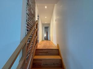 a staircase in a building with a brick wall at Le Domaine de l'Ormurion in Sourdun