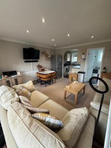 a living room with a couch and a table at 30 Waterside in Corton