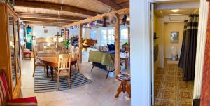 a dining room and living room with a table and chairs at SommerHuset in Samsø +19 photos