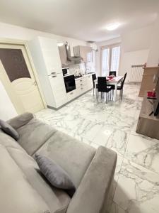 a living room with a couch and a dining room at Sun Beach in San Benedetto del Tronto