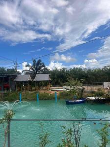 a pool of water with two boats in it at สมหวัง โฮมสเตย์ in Ban Khuan Suan