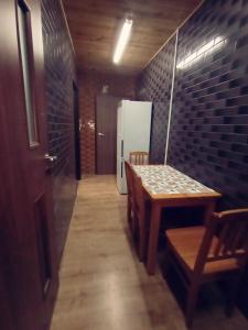 a dining room with a table and a refrigerator at Chmurka in Bęczków