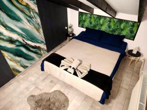 a bedroom with a large bed with a green headboard at Magia Muntelui in Rîmeţi