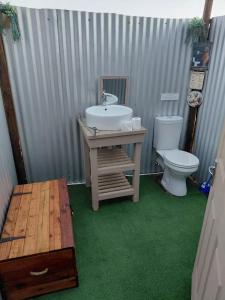 a bathroom with a sink and a toilet at Karoo Stone camper in Ladismith +36 photos