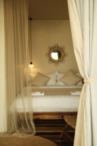 a bedroom with a bed with a mirror and curtains at Sabay Koh Rong in Koh Rong Island