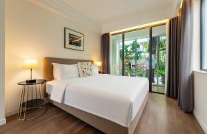 a bedroom with a white bed and a large window at Shenzhen No'6 Garden Villa in Shenzhen +162 photos