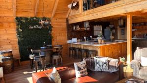 a restaurant with a bar in a wooden cabin at Classy Bear Cabin - Summit Views of Ober Mountain, Hot Tub, 3 King Beds, 2 Mi to Downtown in Gatlinburg