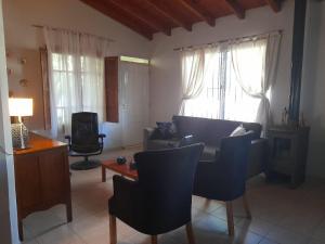 a living room with a couch and chairs and a table at Casita de Frasca in San José de Jáchal