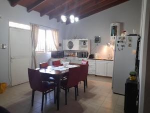 a kitchen with a table and chairs and a refrigerator at Casita de Frasca in San José de Jáchal