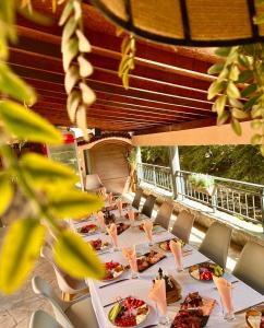 a long table with plates of food on it at Hotel Restaurant Vodenitsata in Berkovitsa