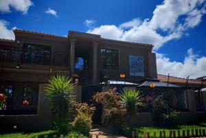 a large house with plants in front of it at Lady D Exclusive Abode in Polokwane