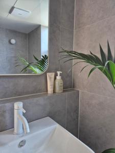 a bathroom with a sink and a mirror at 로프트부산 loft busan in Samgong +29 photos