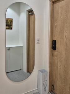 a bathroom with a mirror on the wall at 로프트부산 loft busan in Samgong