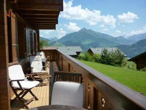 a balcony with chairs and a view of mountains at Chalet Le Murier in Leysin
