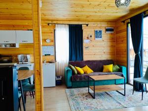 a living room with a couch and a table at Ushguli Highland Cottage in Ushguli
