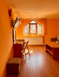 a living room with a table and a dining room at Hotel Restaurant Vodenitsata in Berkovitsa