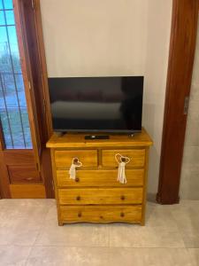 a wooden dresser with a television on top of it at Villa Paula II in Ranchos