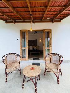 two chairs and a table in a living room at Edwin's Ahangama in Ahangama