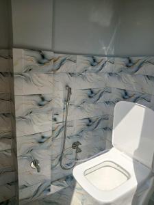 a bathroom with a toilet and a shower at Independent homestay DDN in Dehradun +16 photos