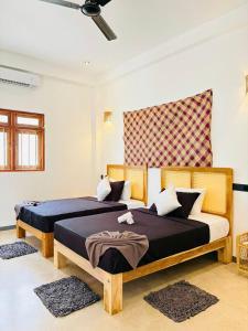 a bedroom with two beds and avisor at Edwin's Ahangama in Ahangama +21 photos
