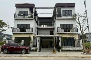 a red car parked in front of a building at De' Mon Villa in Làng Tong Tchoung