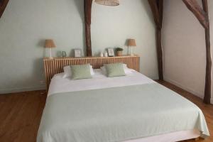 a bedroom with a large white bed with two pillows at Le Petit Manoir avec Piscine Privée in Le Bugue +26 photos