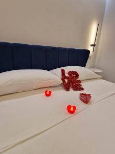 a bed with hearts and a teddy bear on it at Cenvi Suite - Jacuzzi rooms in Mola di Bari