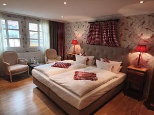 a bedroom with a large bed with two pillows on it at Hotel Goldener Anker in Bayreuth
