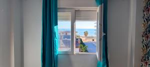 an open window with a view of the ocean at Ocean front apartment Trianon in Daimuz