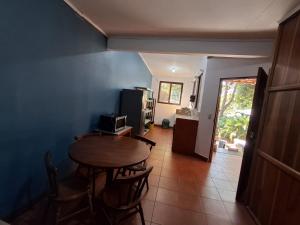 a dining room with a table and a kitchen at Hotel Marielos Tamarindo in Tamarindo