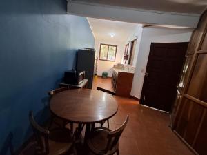 a dining room with a table and chairs and a kitchen at Hotel Marielos Tamarindo in Tamarindo